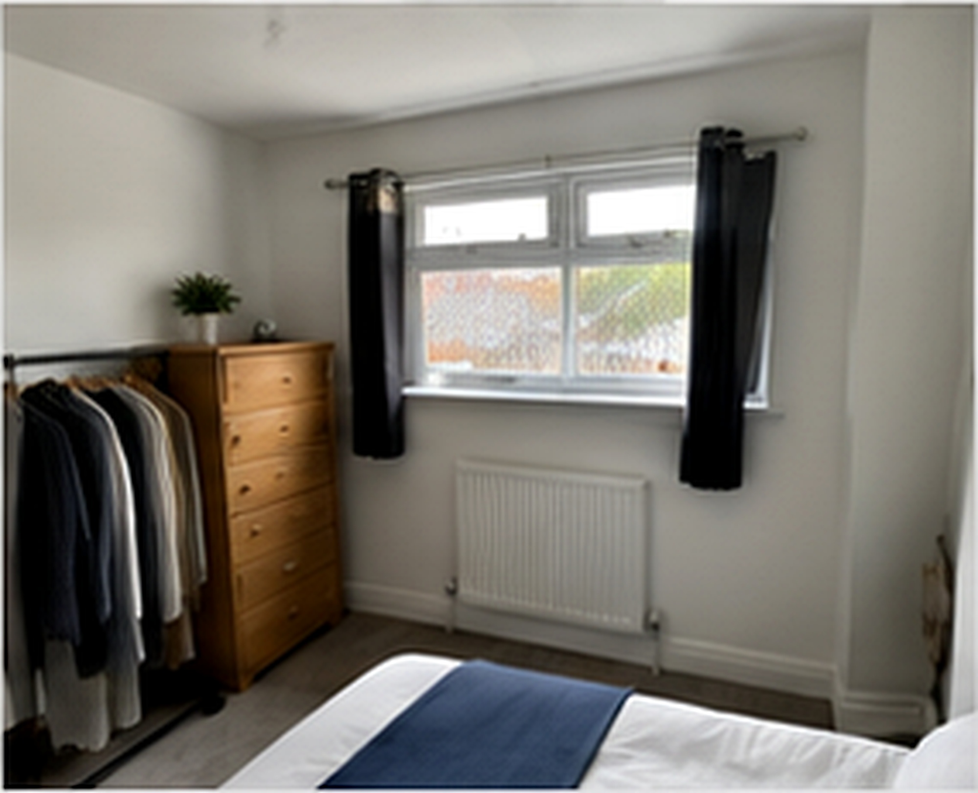 Bedroom with clothes rail at Salford Family House
