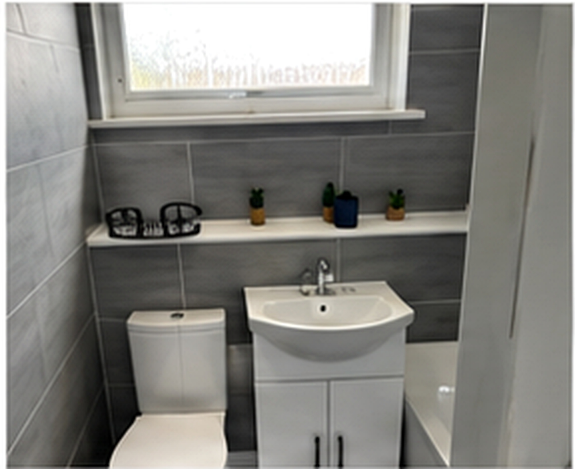 Bathroom toilet and sink at Salford Family House